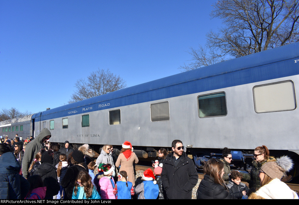 Nickel Plate Sleeper Car # 211 glistens in the sun as the crowd is as jubilent as possible